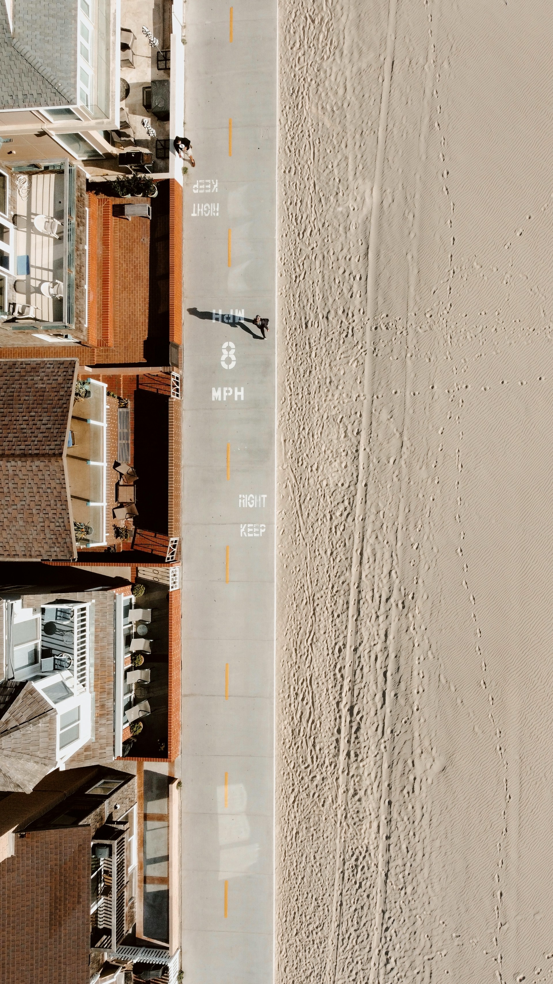 Aerial view of a Newport Beach street running alongside the sand