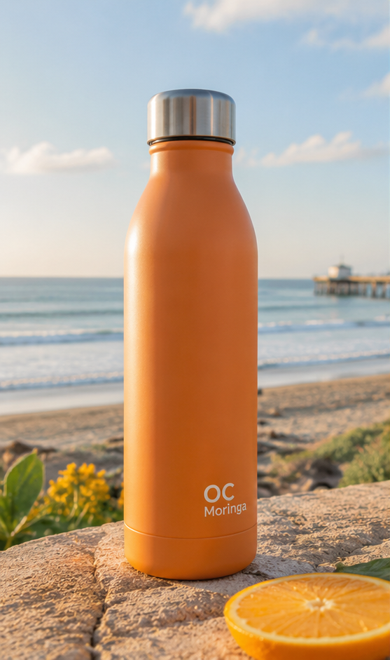 OC Moringa Coastal Steel Bottle on the beach at golden hour