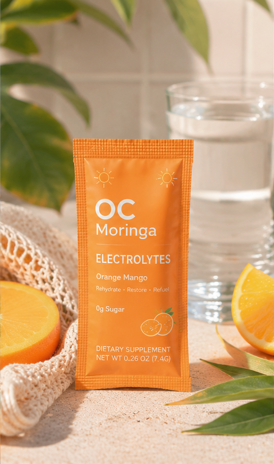 OC Moringa Electrolyte Packets on the beach at golden hour